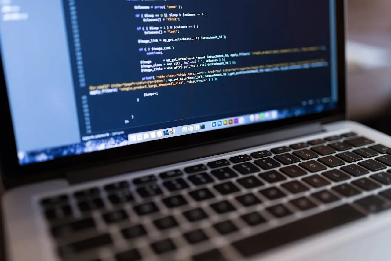 about-us Focused view of programming code displayed on a laptop, ideal for tech and coding themes.